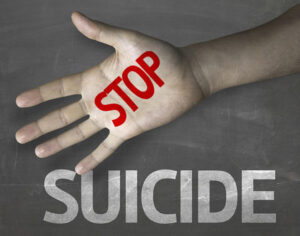Hand with the word "Suicide" written across it in red letters.