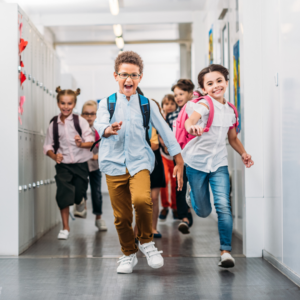 Kids running down a school hallway