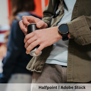 People holding energy drink cans in a social setting.