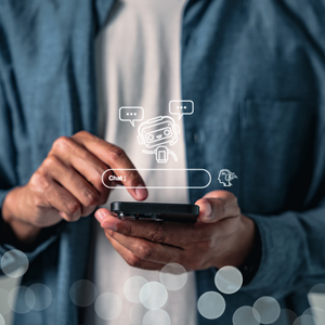 Close-up of a person using a smartphone with AI chatbot icons and a chat interface overlaid above the screen.