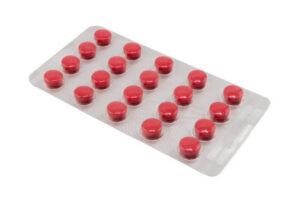Pile of tablets pill in silver blister packaging isolated on white background.